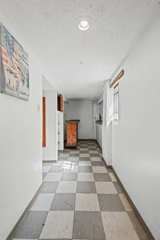 a view of a livingroom with wooden floor and a cabinet