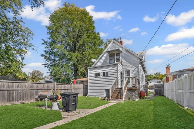 a view of a house with a chairs in a patio