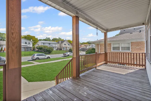 a view of a porch with wooden floor and fence