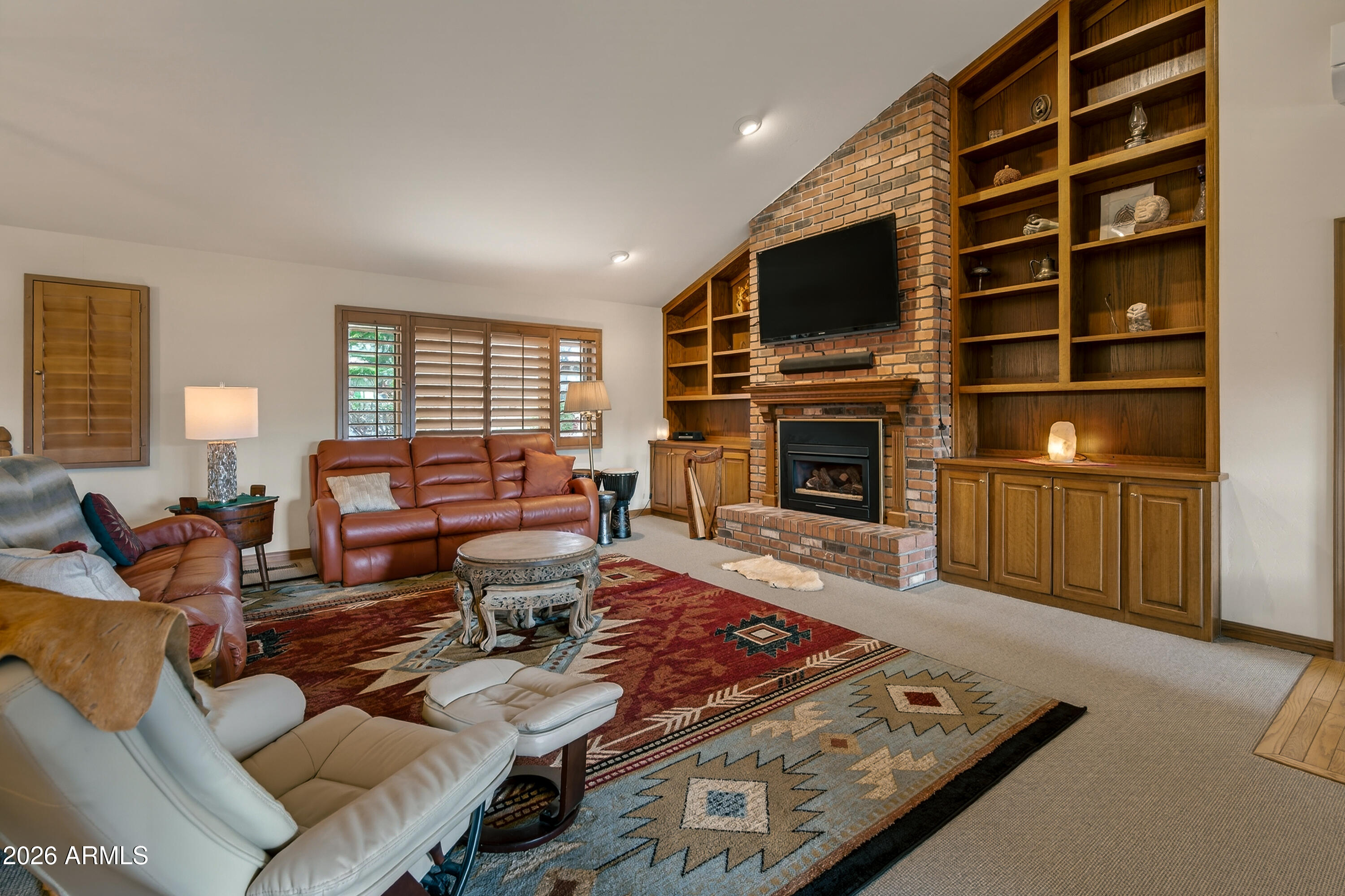 2215 Lariat Road Sedona, AZ 86336 - Photo 12 of 45 a living room with furniture fireplace and flat screen tv