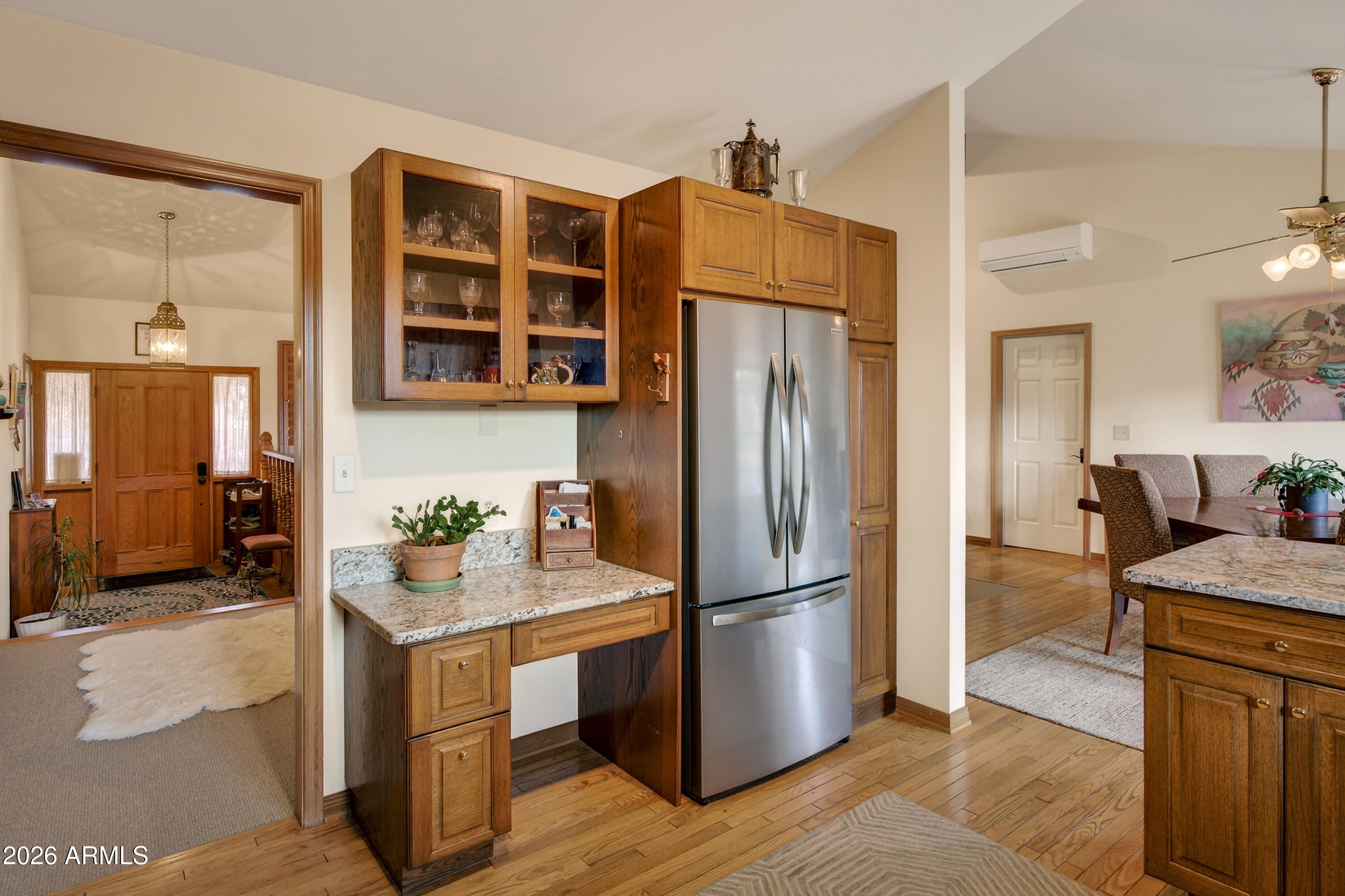 2215 Lariat Road Sedona, AZ 86336 - Photo 22 of 45 a kitchen with a refrigerator cabinets and wooden floor