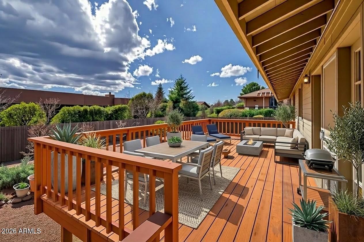 2215 Lariat Road Sedona, AZ 86336 - Photo 32 of 45 a balcony with wooden floor and outdoor seating