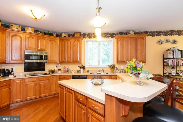 a kitchen with a sink a counter and chairs