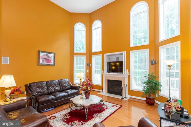 a living room with furniture fireplace and a large window