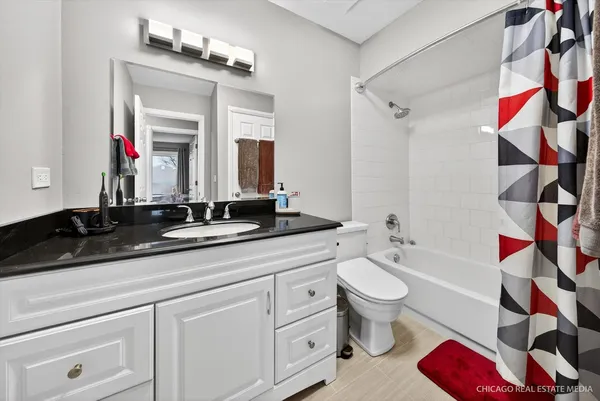a bathroom with a double vanity sink mirror and toilet