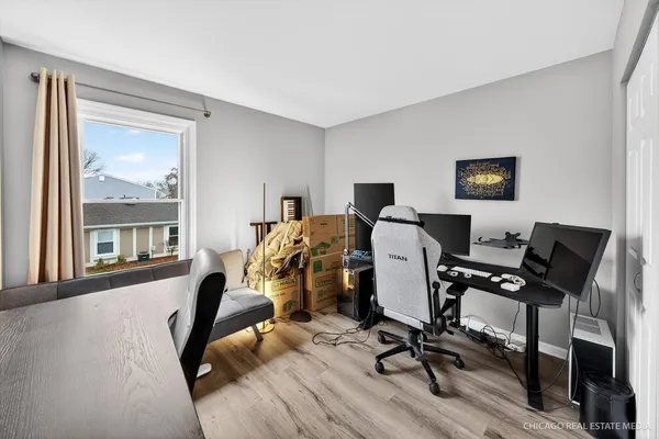 a view of a workspace with furniture and a window
