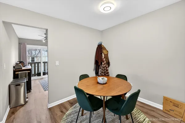 a view of a dining room with a table and chairs