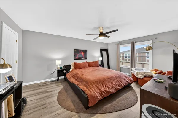 a bedroom with a bed and wooden floor