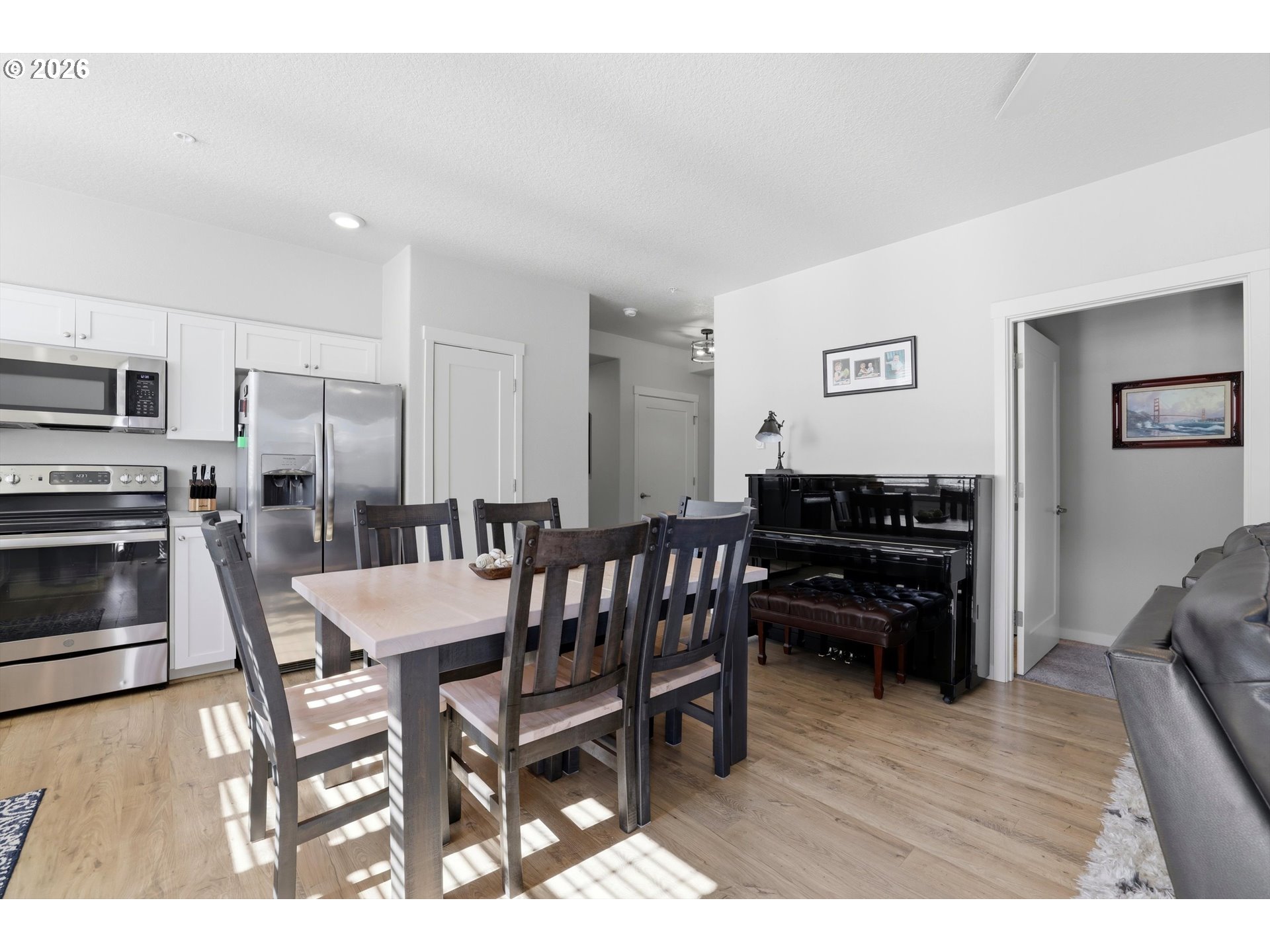 17149 Southwest Snowdale Street, Unit 103 Beaverton, OR 97007 - Photo 13 of 48 a dining room with furniture and wooden floor