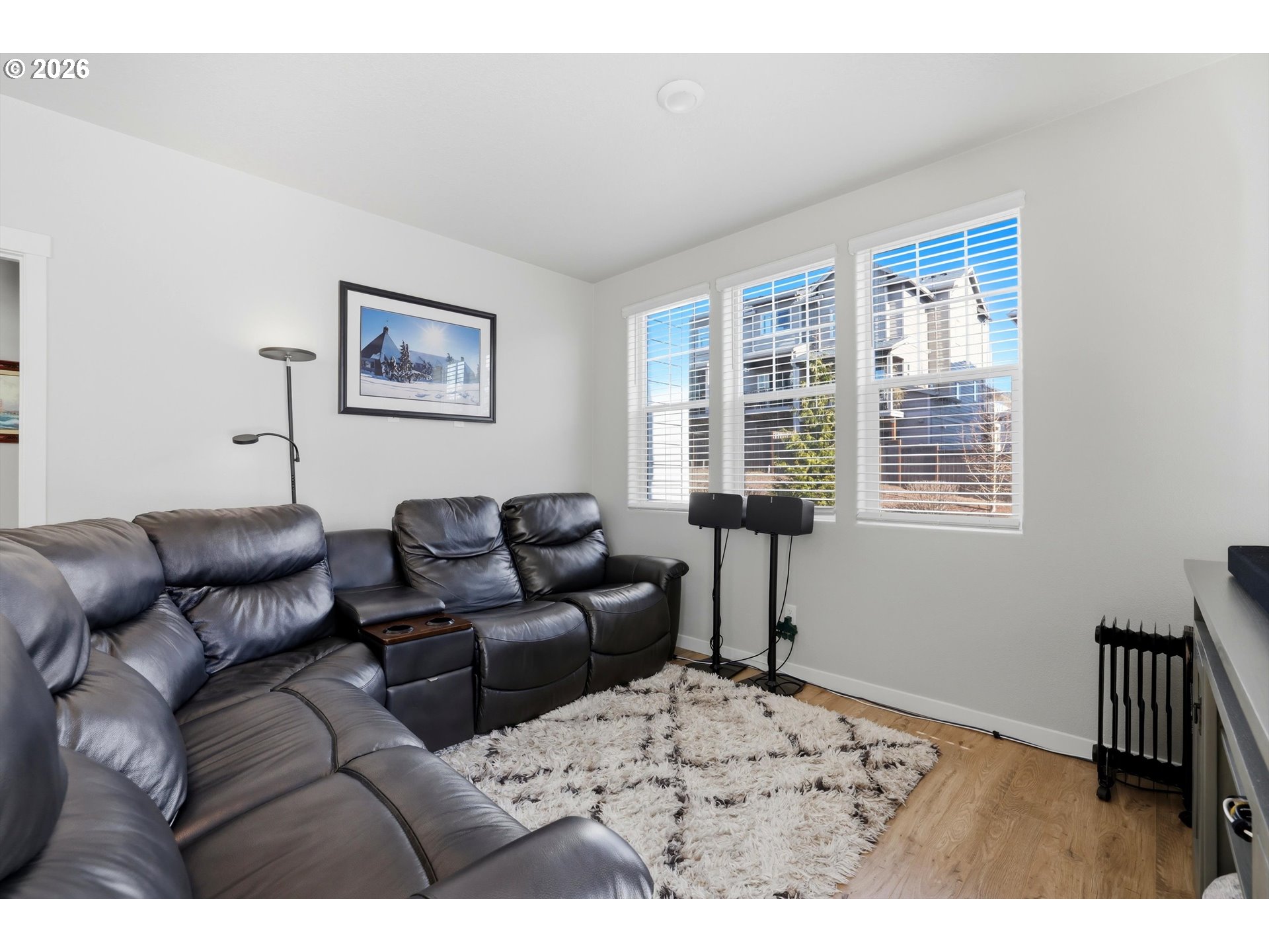 17149 Southwest Snowdale Street, Unit 103 Beaverton, OR 97007 - Photo 15 of 48 a living room with furniture a window and a wooden floor