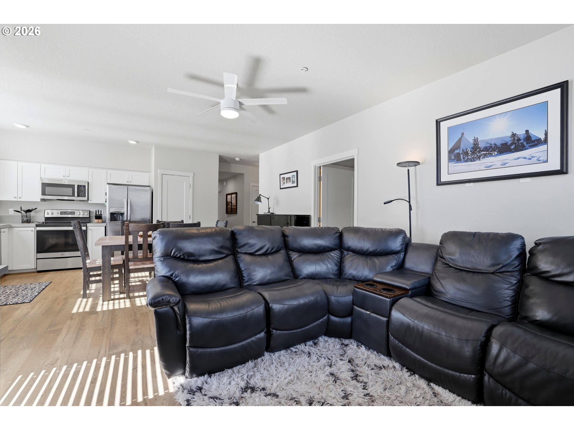 17149 Southwest Snowdale Street, Unit 103 Beaverton, OR 97007 - Photo 19 of 48 a living room with furniture a rug and kitchen view