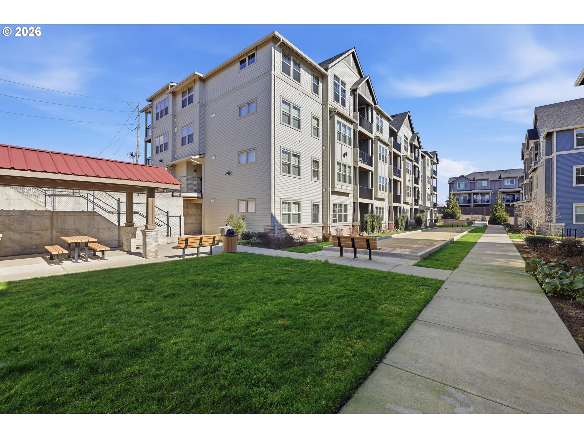 17149 Southwest Snowdale Street, Unit 103 Beaverton, OR 97007 - Photo 2 of 48 a view of a building with a yard