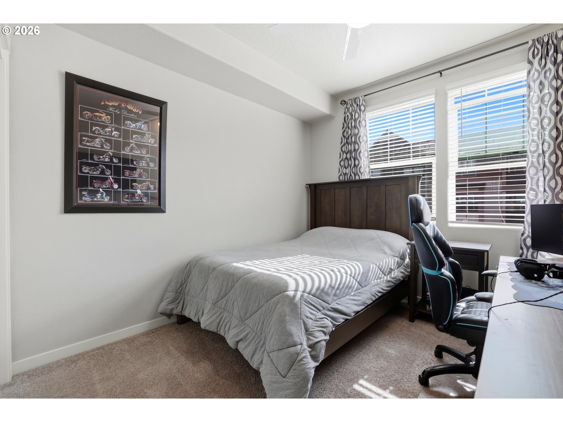 17149 Southwest Snowdale Street, Unit 103 Beaverton, OR 97007 - Photo 30 of 48 a bedroom with a bed a table and chair