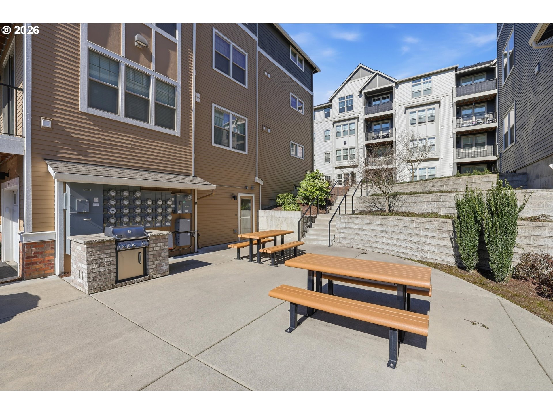 17149 Southwest Snowdale Street, Unit 103 Beaverton, OR 97007 - Photo 46 of 48 a building outdoor space with patio furniture and potted plants