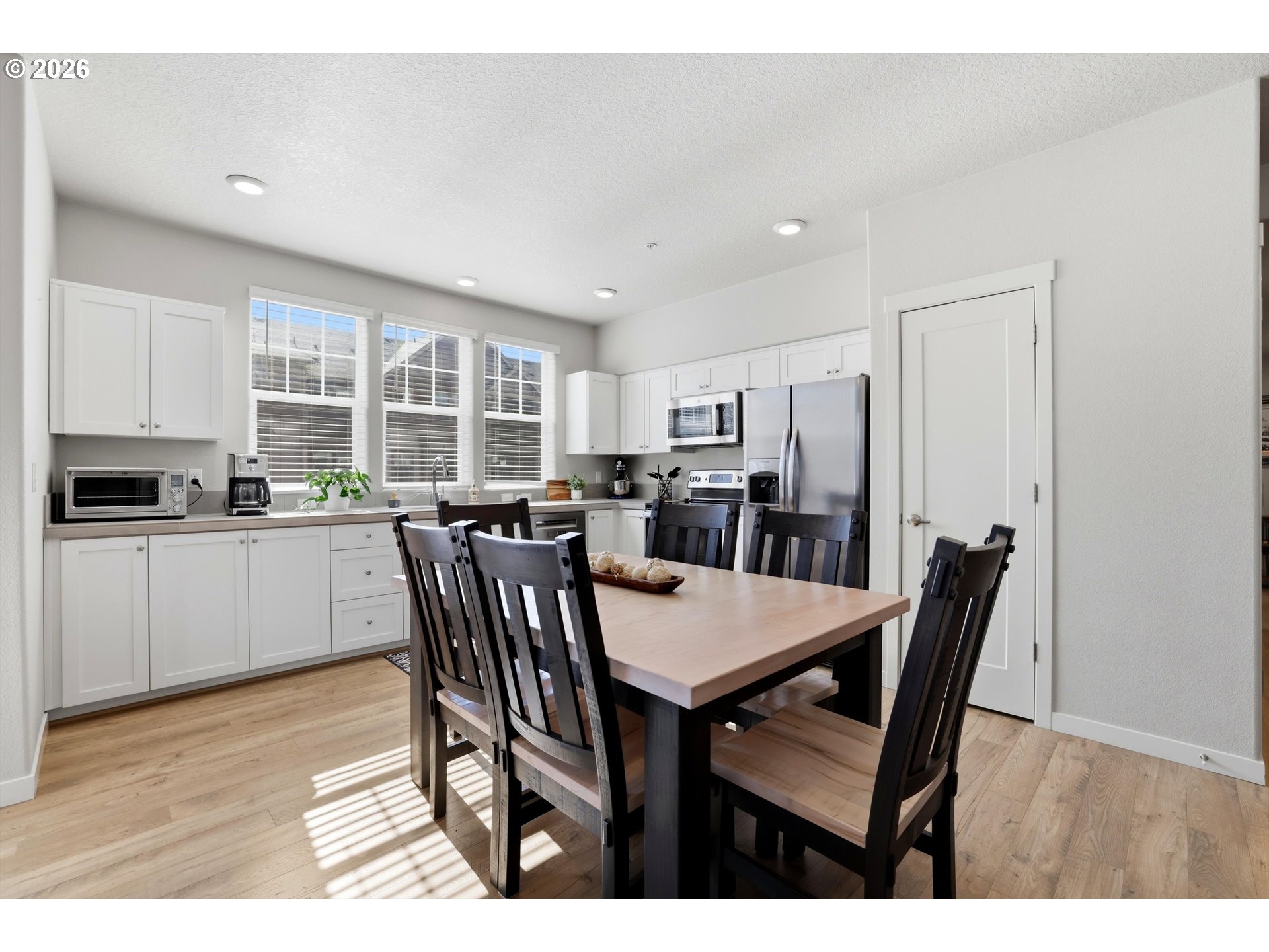 17149 Southwest Snowdale Street, Unit 103 Beaverton, OR 97007 - Photo 9 of 48 a view of a dining room with furniture and wooden floor