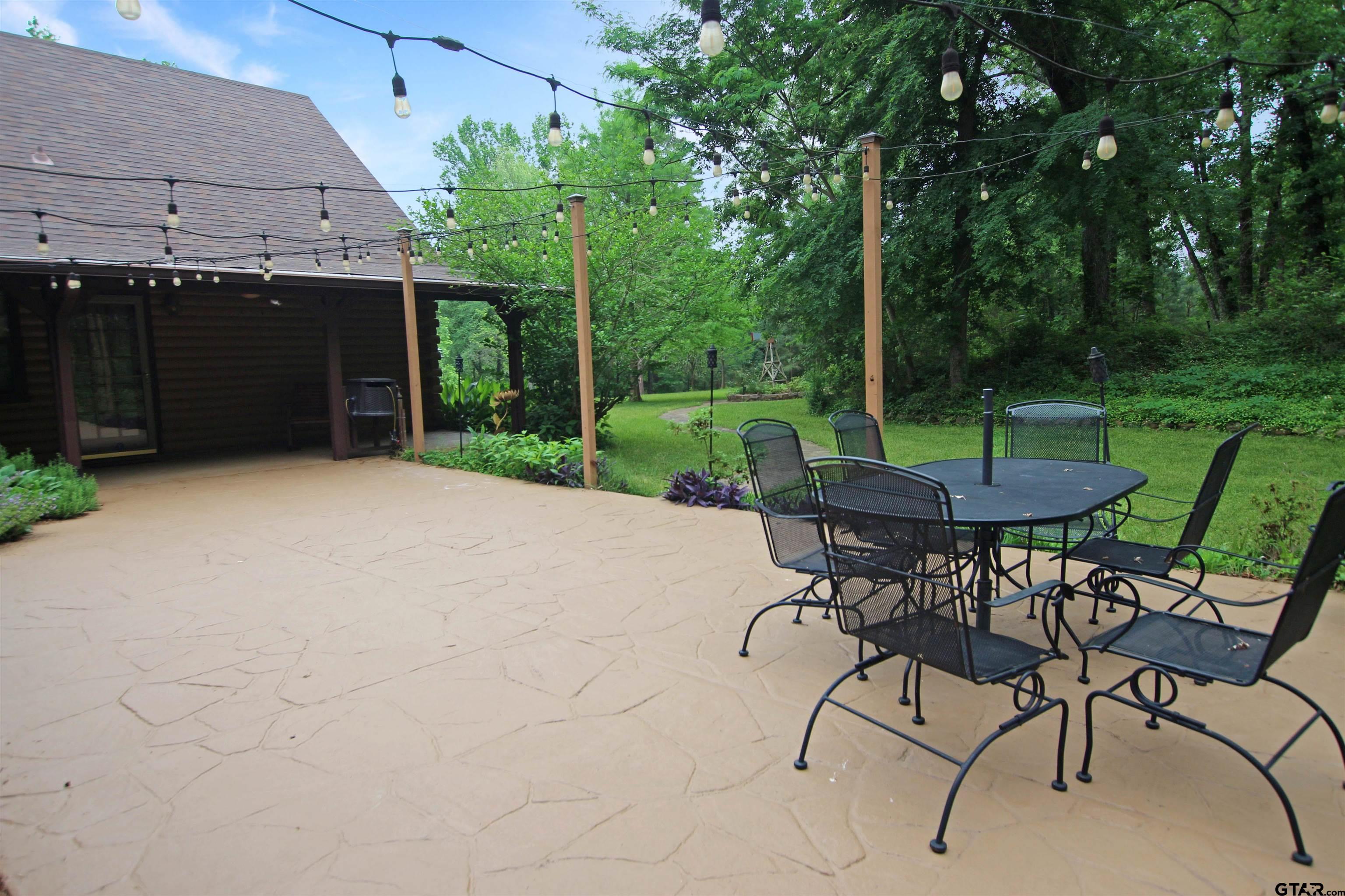 782 Rosie Wady Road Gladewater, TX 75647 - Photo 25 of 48 a view of a backyard with furniture and a garden