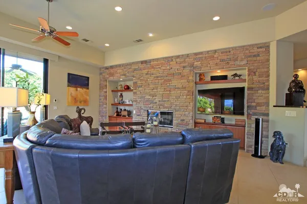 a living room with fireplace furniture and a flat screen tv