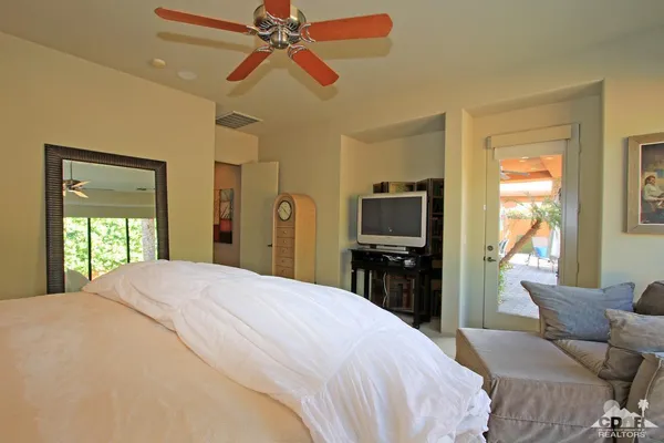 a spacious bedroom with a bed and furniture