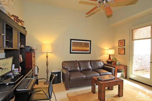 a view of an outdoor sitting area with furniture and umbrella