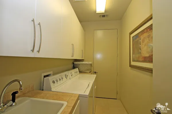 a backyard of a house with a yard and outdoor seating