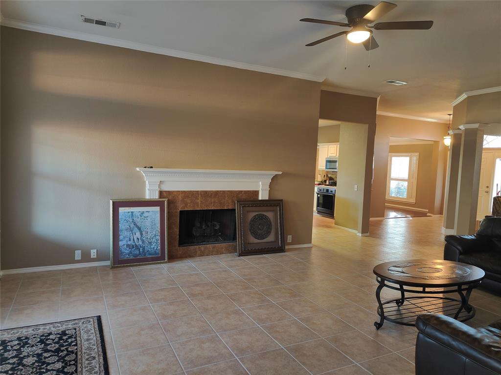 7900 Roaring Ridge Drive Plano, TX 75025 - Photo 14 of 34 a living room with furniture and a fireplace