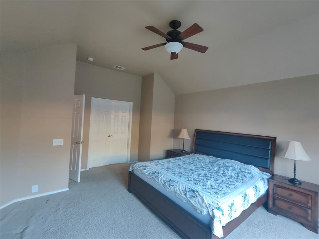 7900 Roaring Ridge Drive Plano, TX 75025 - Photo 21 of 34 a bedroom with a large bed and a chandelier