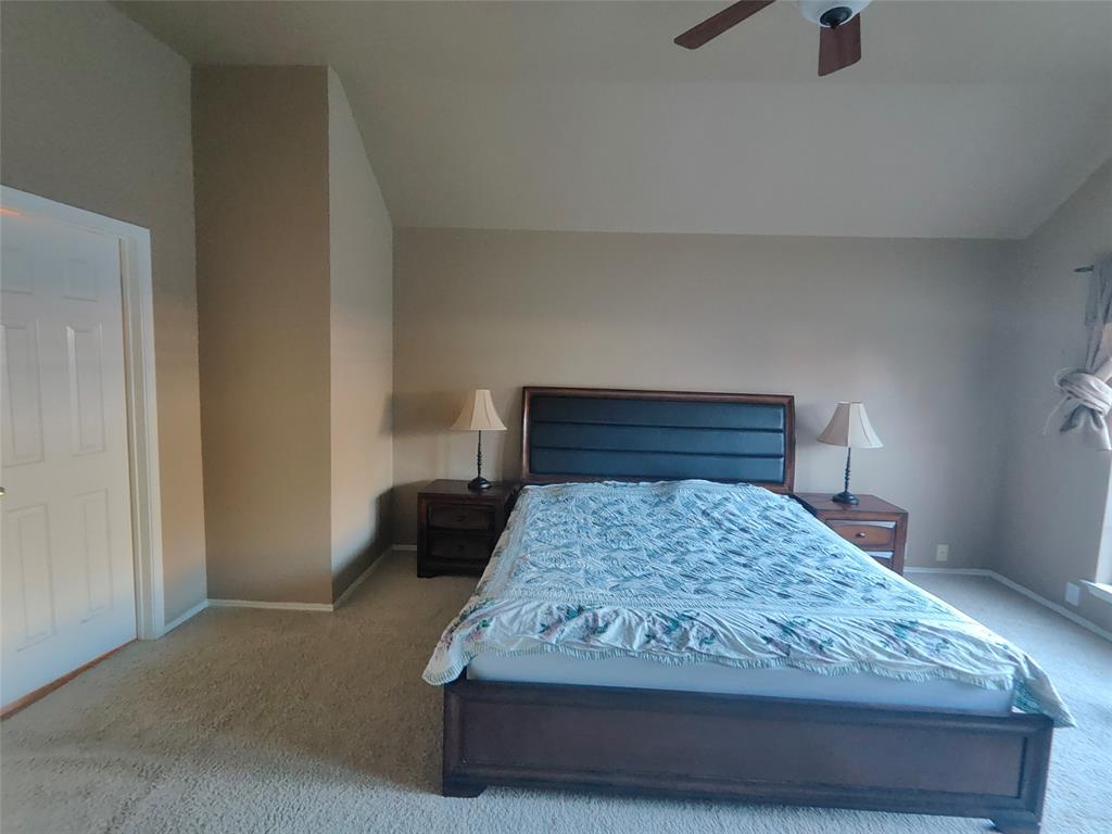 7900 Roaring Ridge Drive Plano, TX 75025 - Photo 22 of 34 a bed sitting in a bedroom next to a window with a dresser