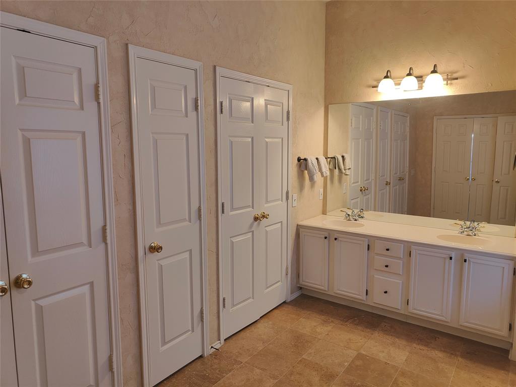 7900 Roaring Ridge Drive Plano, TX 75025 - Photo 24 of 34 a spacious bathroom with a double vanity sink mirror and shower
