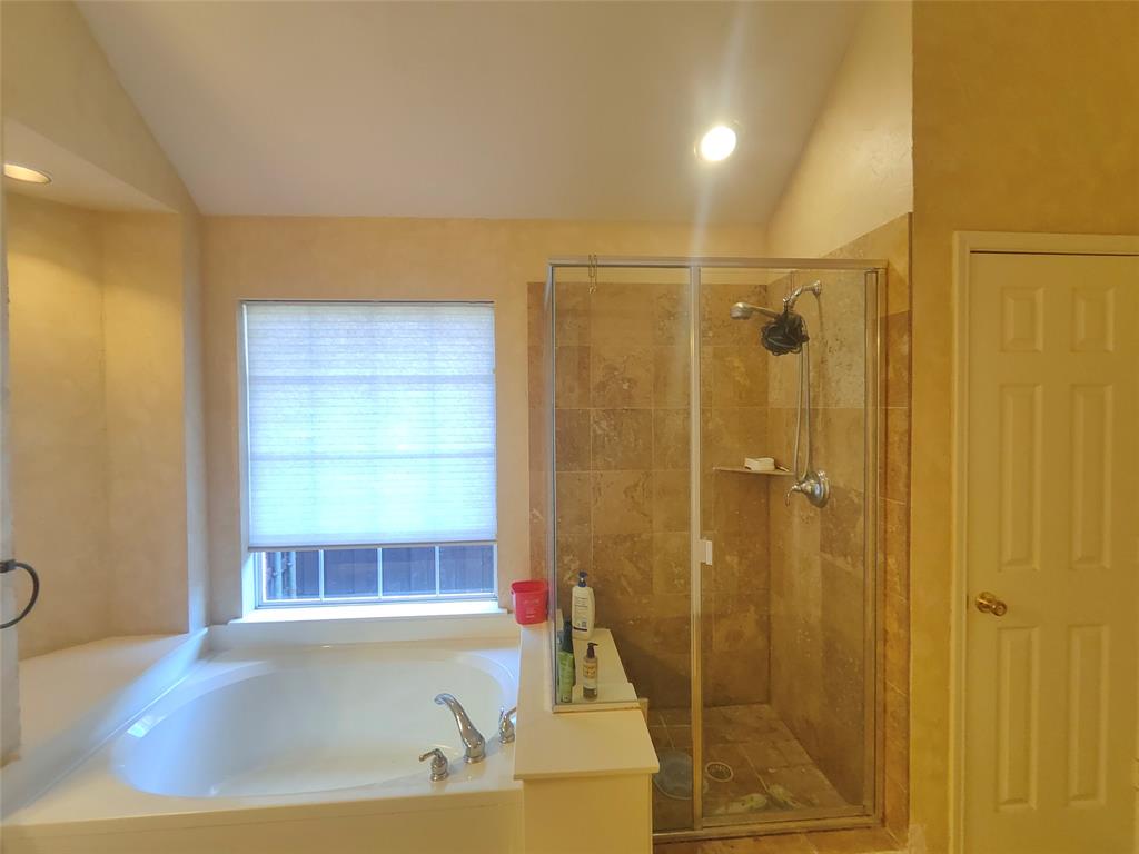 7900 Roaring Ridge Drive Plano, TX 75025 - Photo 27 of 34 a bathroom with a tub and shower