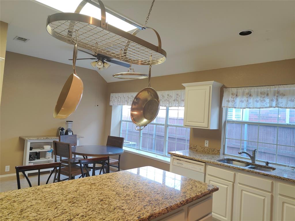 7900 Roaring Ridge Drive Plano, TX 75025 - Photo 9 of 34 a kitchen with stainless steel appliances granite countertop a sink a stove and a wooden floors