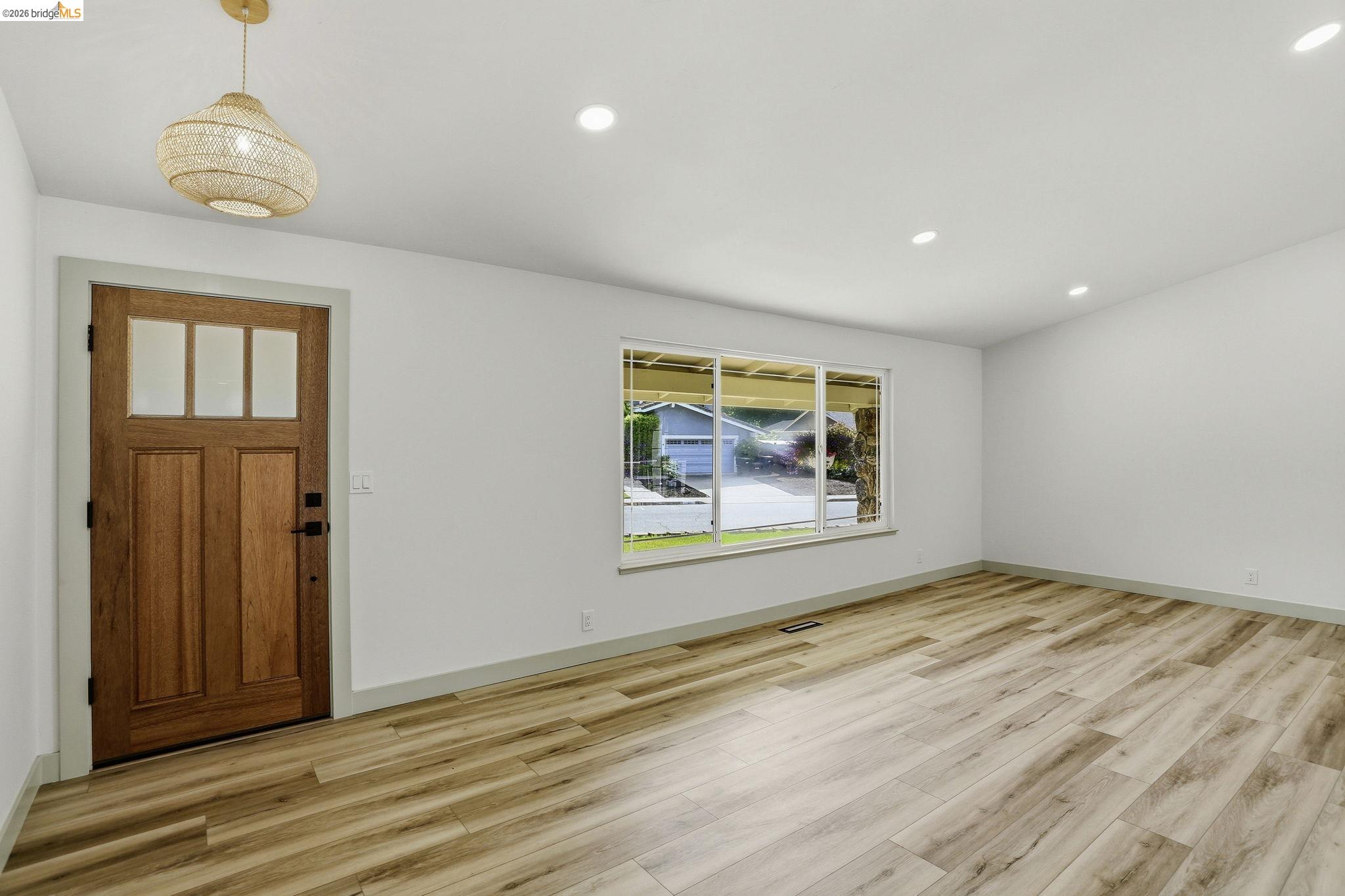 2438 Merritt Place Livermore, CA 94550 - Photo 11 of 64 a view of an empty room with wooden floor and a window