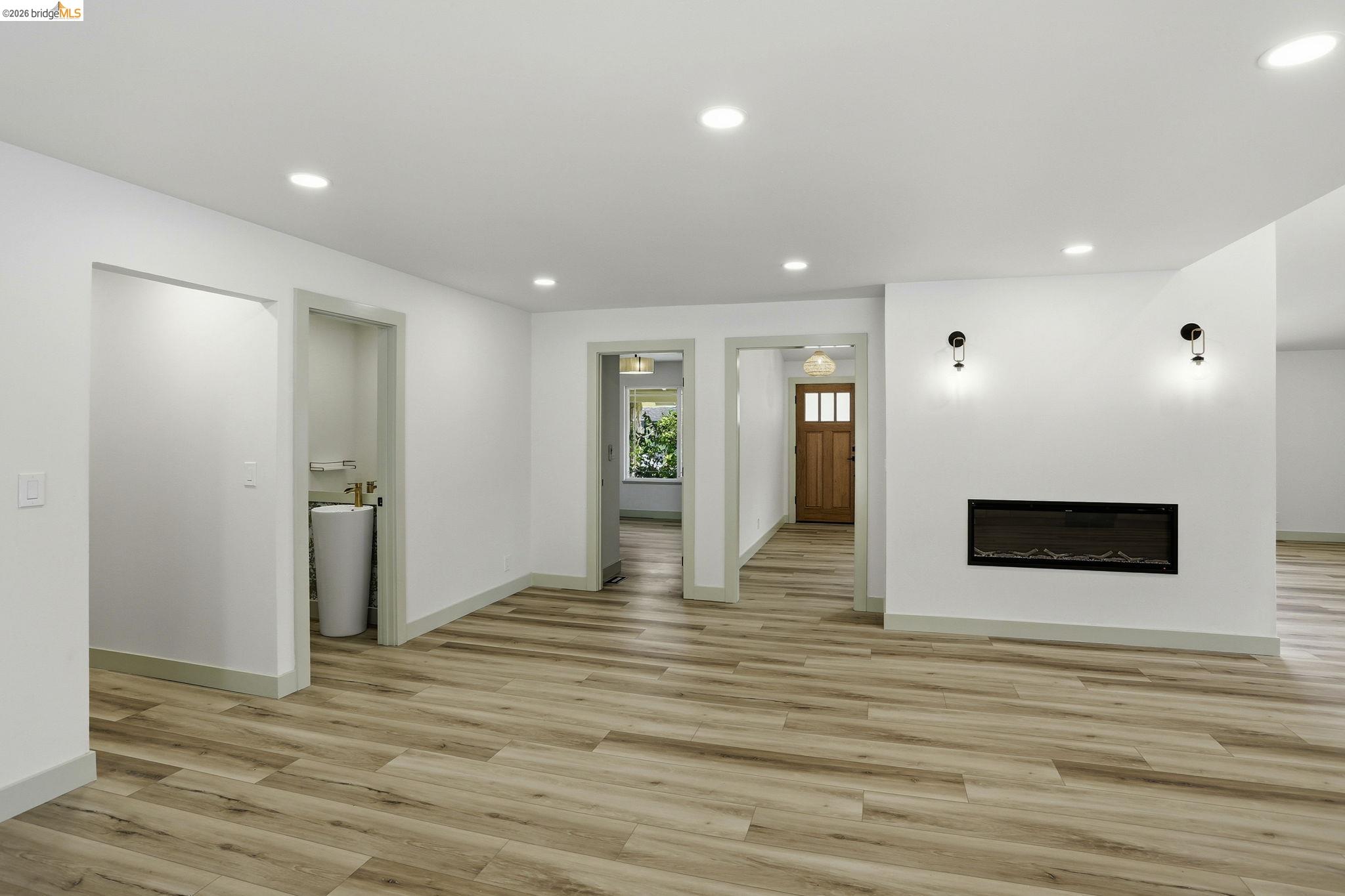 2438 Merritt Place Livermore, CA 94550 - Photo 13 of 64 Unfurnished living room with a glass covered fireplace, light wood finished floors, and recessed lighting