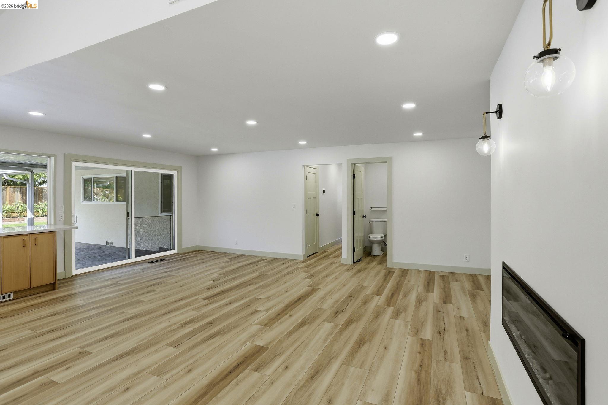 2438 Merritt Place Livermore, CA 94550 - Photo 14 of 64 a view of an empty room with wooden floor and a window