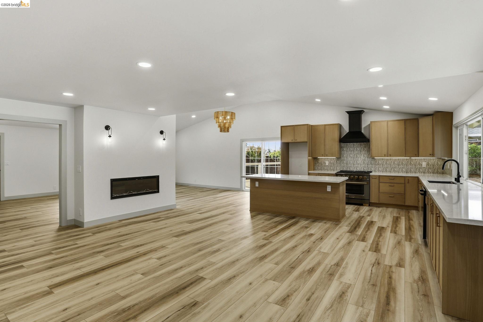 2438 Merritt Place Livermore, CA 94550 - Photo 63 of 64 a large kitchen with kitchen island a sink wooden floor and stainless steel appliances