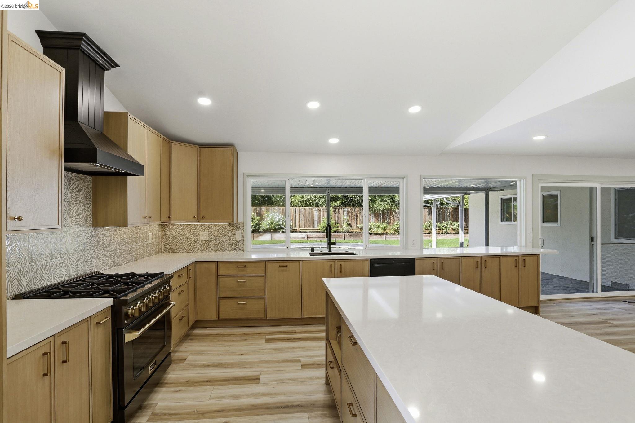 2438 Merritt Place Livermore, CA 94550 - Photo 18 of 64 a large kitchen with stainless steel appliances granite countertop a lot of counter space and a sink
