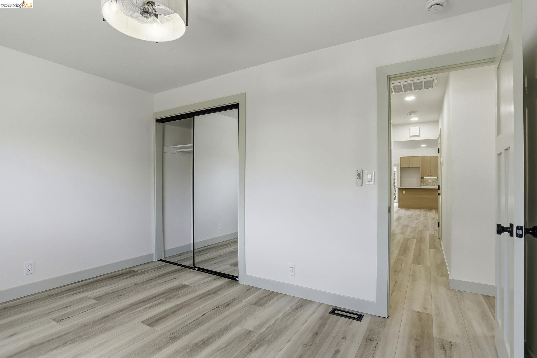 2438 Merritt Place Livermore, CA 94550 - Photo 29 of 64 an empty room with wooden floor and windows
