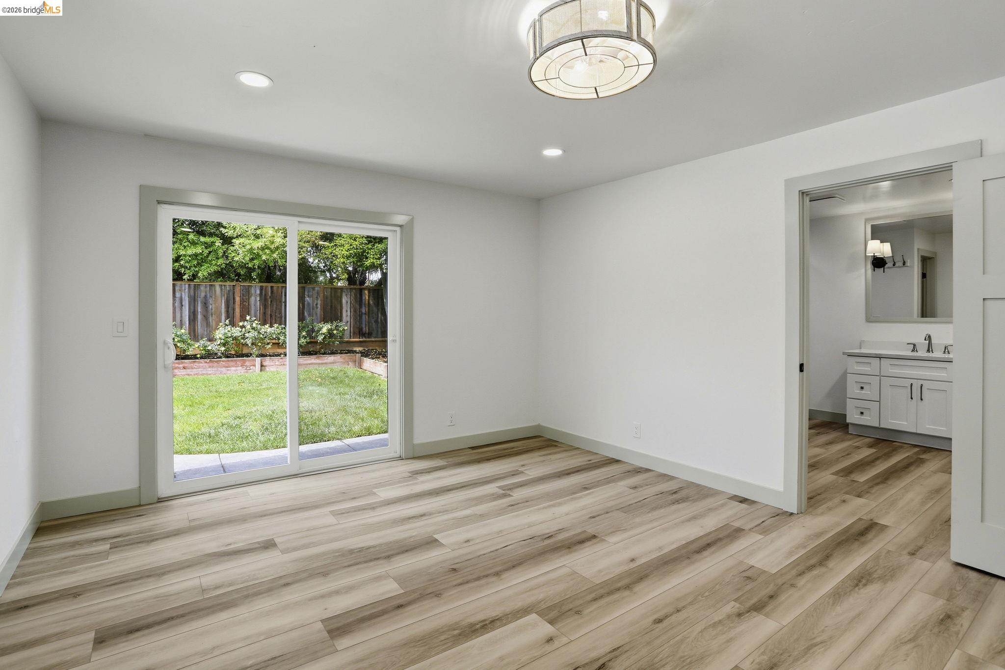 2438 Merritt Place Livermore, CA 94550 - Photo 32 of 64 a view of an empty room with wooden floor and a window