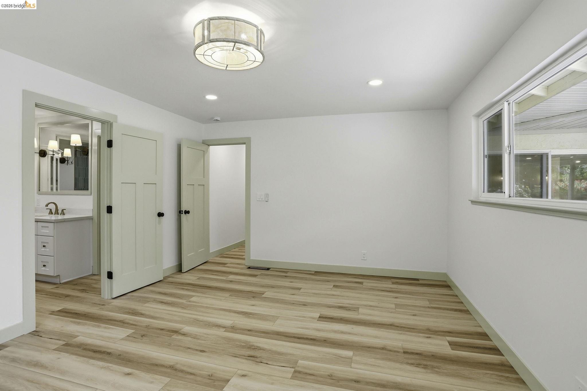 2438 Merritt Place Livermore, CA 94550 - Photo 33 of 64 an empty room with wooden floor and windows
