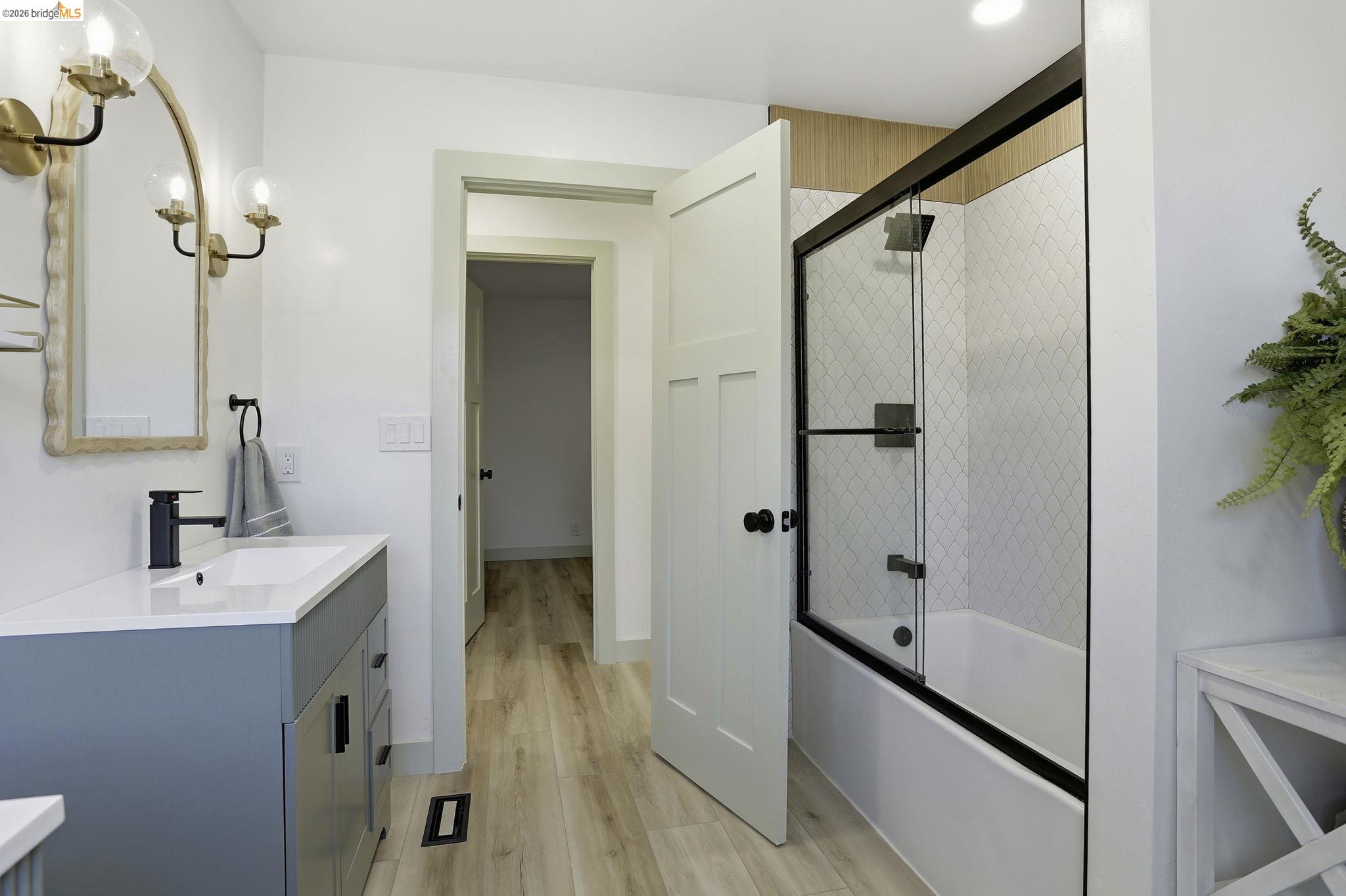 2438 Merritt Place Livermore, CA 94550 - Photo 40 of 64 a bathroom with a double vanity sink a mirror and a bathtub