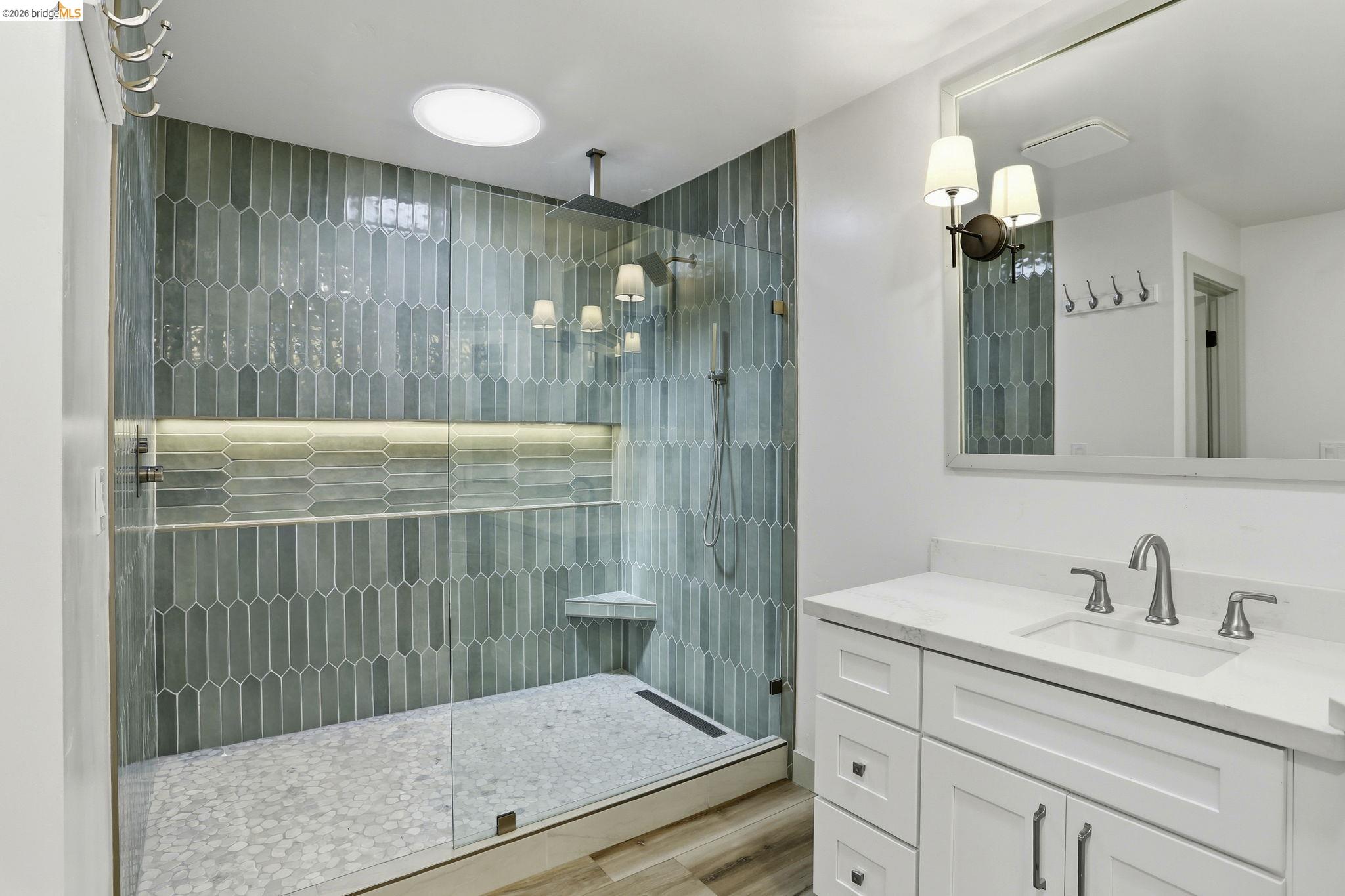 2438 Merritt Place Livermore, CA 94550 - Photo 42 of 64 a bathroom with a granite countertop sink a mirror and shower