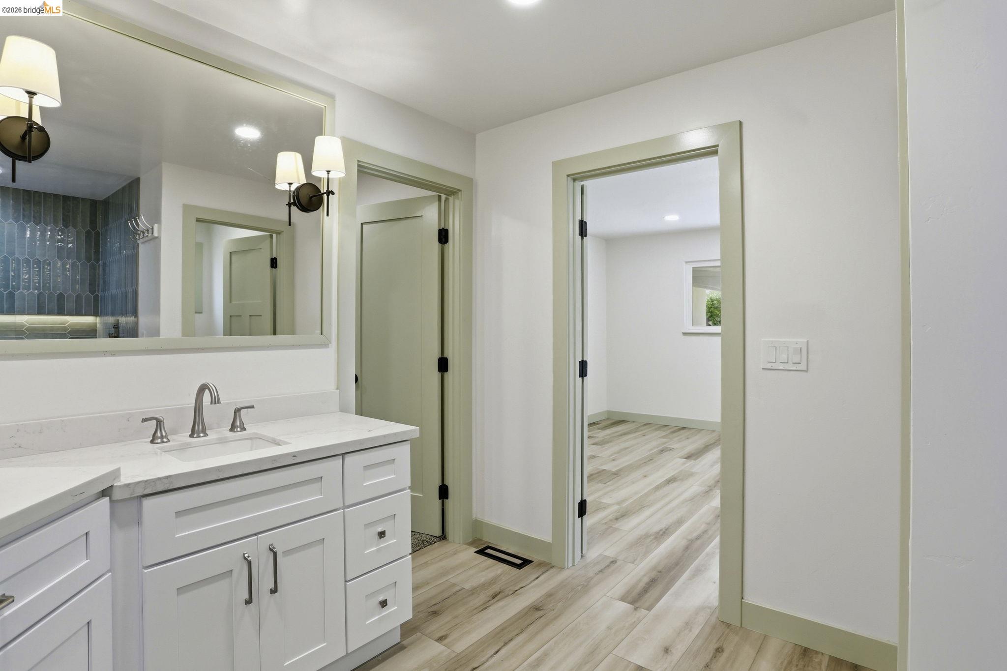 2438 Merritt Place Livermore, CA 94550 - Photo 43 of 64 a bathroom with a sink a mirror a vanity and a shower