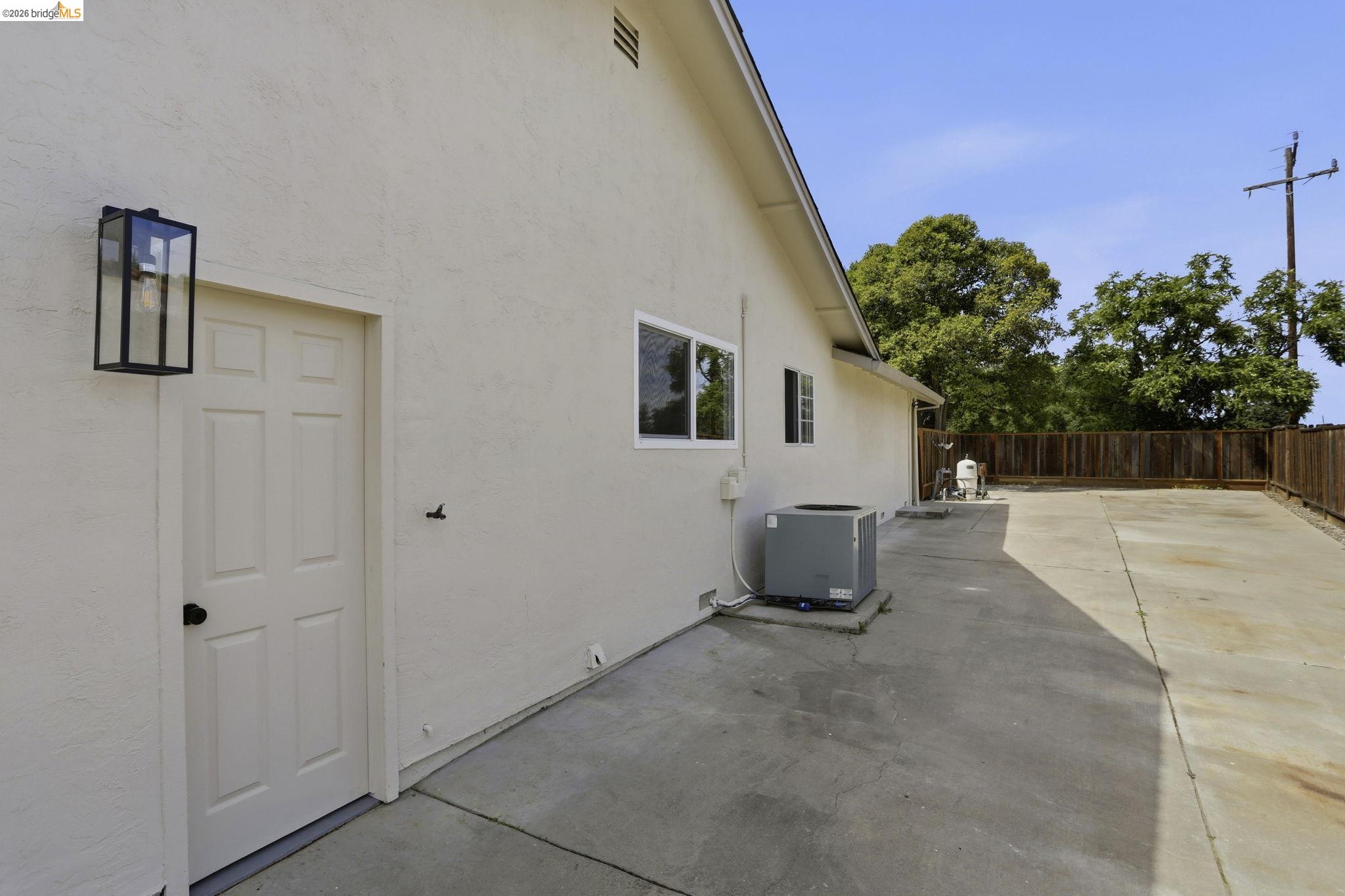 2438 Merritt Place Livermore, CA 94550 - Photo 47 of 64 View of home's exterior featuring stucco siding, a patio, and a fenced backyard