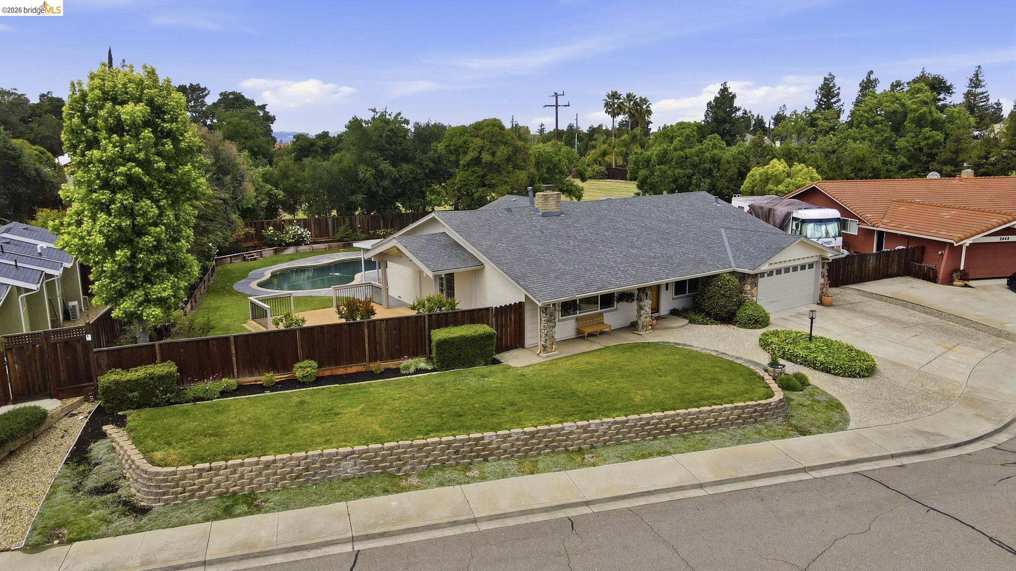 2438 Merritt Place Livermore, CA 94550 - Photo 8 of 64 Ranch-style home with driveway, a garage, a shingled roof, a chimney, and stone siding