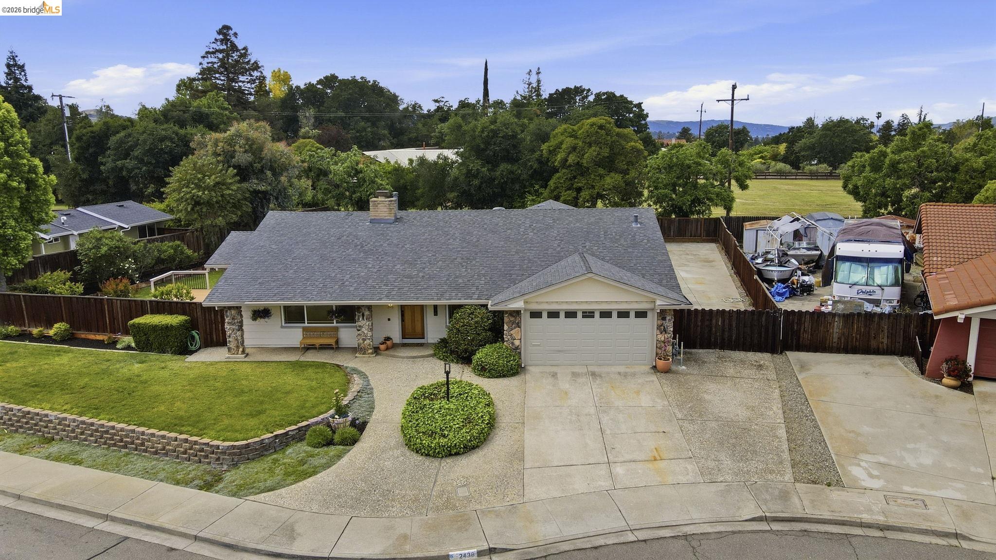 2438 Merritt Place Livermore, CA 94550 - Photo 9 of 64 View of front of house with a garage, a porch, concrete driveway, a chimney, and a shingled roof
