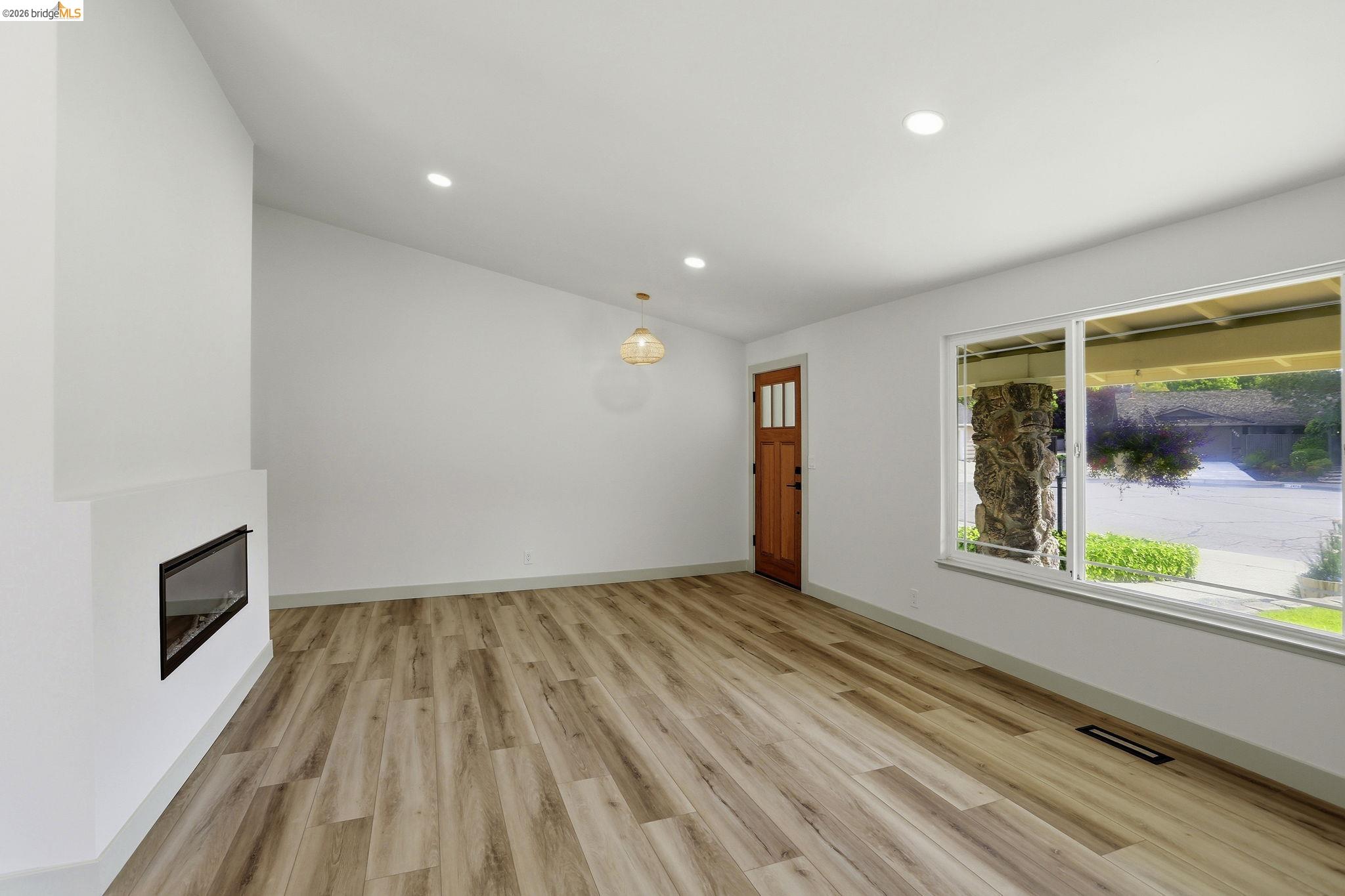 2438 Merritt Place Livermore, CA 94550 - Photo 10 of 64 a view of an empty room with wooden floor and a window