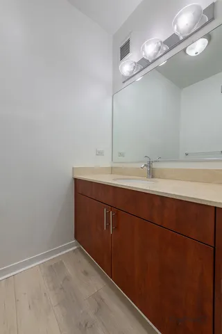 a bathroom with a sink vanity and a mirror