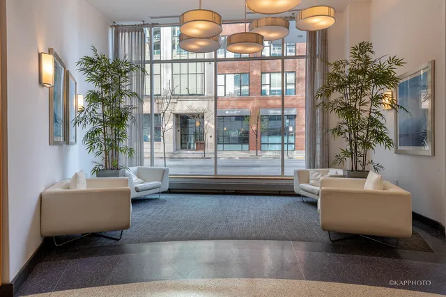 a living room with couches and a potted plant