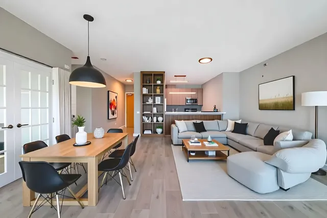 a living room with furniture and wooden floor
