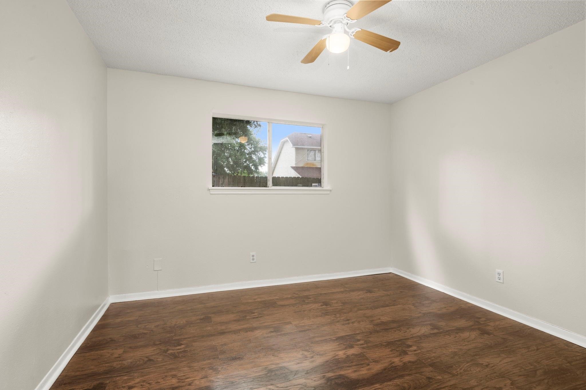 11718 Ridge Run Drive Houston, TX 77064 - Photo 9 of 17 an empty room with wooden floor and fan
