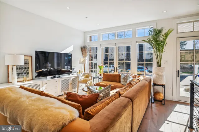 a living room with furniture and floor to ceiling windows